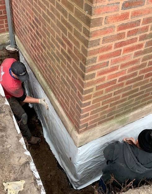 Foundation waterproofing work on brick building NYC